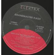 GRANDMASTER FLASH  - GIRLS LOVE THE WAY HE SPINS ( VOCAL LP VERSION ) / LARRY'S DANCE THEME ( TRIBUTE TO THE ELECTRIC BOOGIERS )